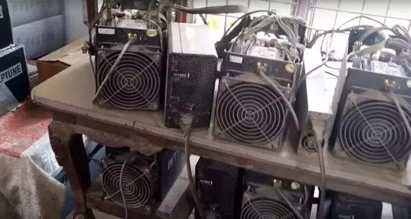 A frustrated Bitcoin miner staring at a malfunctioning rig